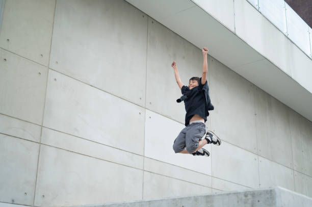 istock Young man jumping energetically in front of a residential complex 2149437394