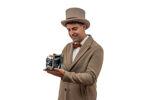 vintage photographer holding an old-fashioned camera. His timeless attire and genuine expression evoke a sense of nostalgia, capturing the essence of photography in bygone eras white background