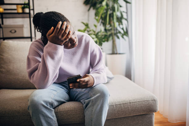 istock Young woman stressed over phone message at home 2149439345