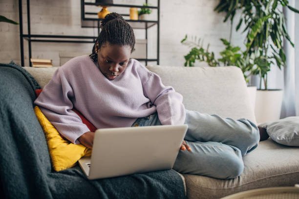 istock Young woman working on laptop at home 2149442155