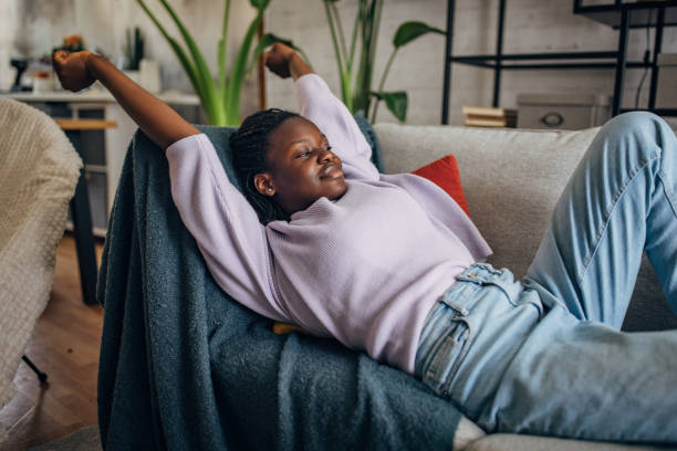 istock Relaxed young black woman enjoying time at home 2149442451