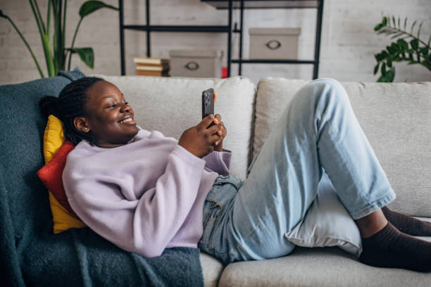 istock Young woman enjoying time on smartphone at home 2149442853