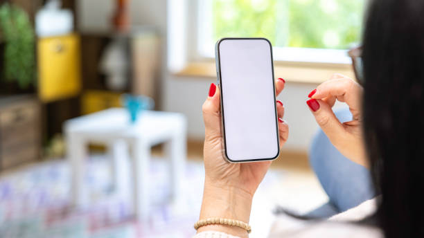 istock Woman holding mobile phone with blank desktop white screen 2149442904