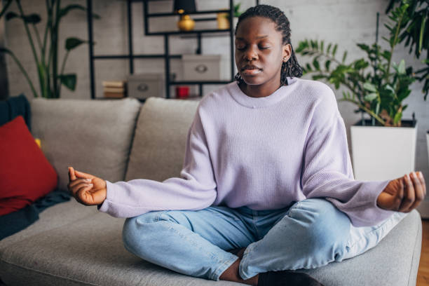 istock Serene young black woman meditating at home 2149443722