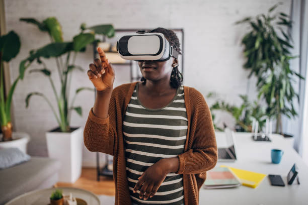 istock Young woman experiencing virtual reality at home 2149445295