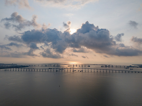 Aerial view of Macau Bridge and Macau Friendship Bridge during cloudy weather at sunrise