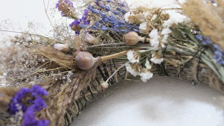 wreath of dried herbs Poppy spikelets of wheat predominance of blue dried herbs in decoration on the wall we will weave a wreath With love, handmade art Dried wildflowers create the atmosphere.