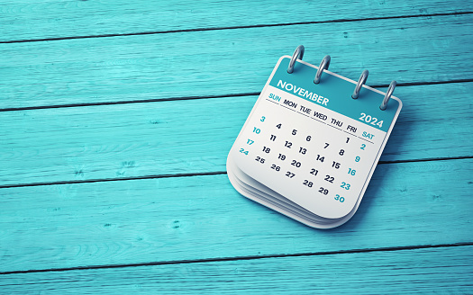 3d render November 2024 Desk Calendar sitting onTurquoise Wooden background, Can be used for reminder day, special day concept (Close-Up)