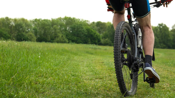 Mature Man Cycling to Keep in Shape in Spring. Outdoor Exercises.