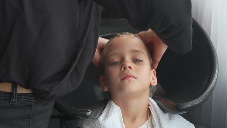 Girl having her hair washed with shampoo in salon