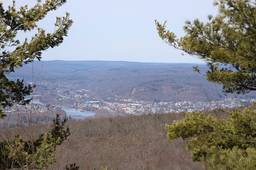 The Beauty of Nature in the three-state border at New Jersey High Point State Park. A populated valley surrounded by the Delaware River through the trees. The trees are an important component of the high-elevation parking lot and recreation area, plagued with low-altitude vegetation in the alpine belt.