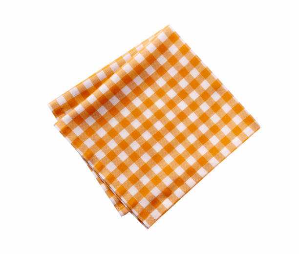 istock Folded checked yellow tablecloth isolated on white.Picnic orange cloth,dish towel,food decor. 2149453794