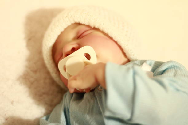 Precious little boy sound asleep hugging his teddybear.