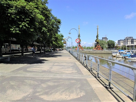 Buenos Aires, Argentina - 02/17/2024. The pedestrian walkway at the Puerto Madero waterfront. Buenos Aires cityscape.