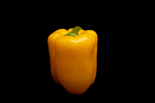 Spicy yellow pepper in black background