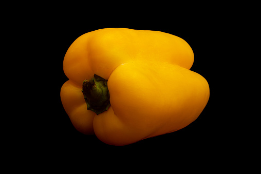 Spicy yellow pepper in black background