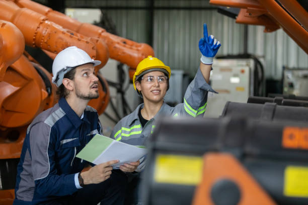 istock Engineers working robot assembly industry plant in factory examining condition inspection quality robotic arm. teamwork technician robotic industrial. 2149458678
