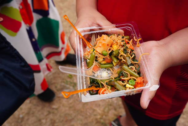 istock The boy holding a fork with fried noodle food on street 2149463177