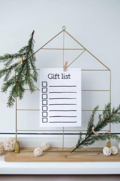 istock Preparation for winter holidays. GIFT LIST text on paper note. Celebration gifts and presents preparing Natural zero waste homemade Christmas decor. Happy new year 2149464864