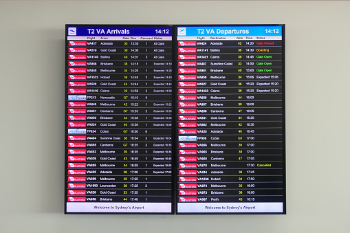 An arrival and departure board on a wall in the Virgin Australia domestic terminal of Sydney Kingsford-Smith Airport. The photographer was taking flight VA850 to Melbourne. This image was taken on a sunny afternoon on 1 April 2024