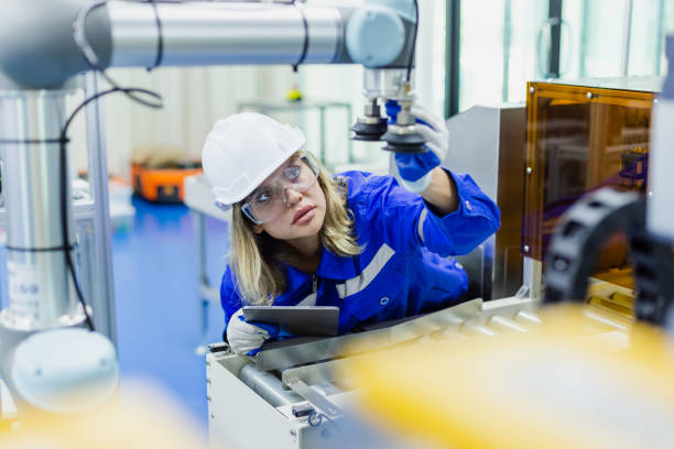 istock female technician engineer wear uniform with helmet safety checking automation robot arm at industrial modern factory. woman working at factory innovation automation robot. equipment instead of worker 2149465551