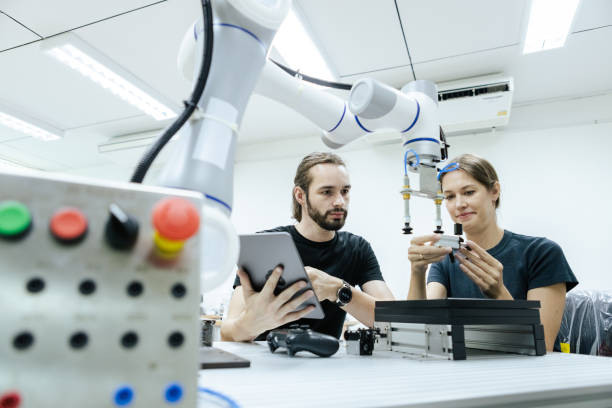 istock Male and female using tablet staff engineer with robot for education at class room. Education for future robotics learning innovation. Workshop maintenance technical. 2149465614