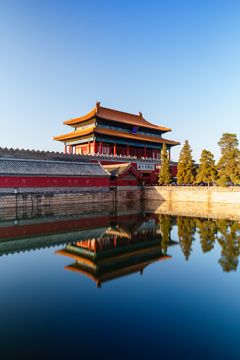 The Gate of Divine Prowess is also the north gate of  Forbidden City. The photo shows the gate is covered by golden sunlight in the morning with reflection on still water in the moat surrounded the Forbidden City.