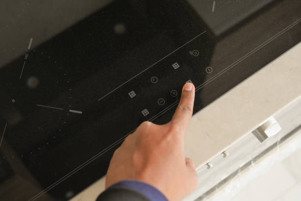 istock man hand turning on the ceramic black induction stove 2149467508