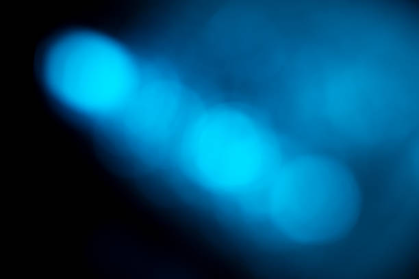 Blurred blue lights abstract background. Defocused glittering lights. Colorful wallpaper for design