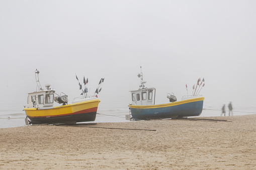 Beach in the fog, fishing boats in the foreground. Baltic Sea, Sopot, Poland