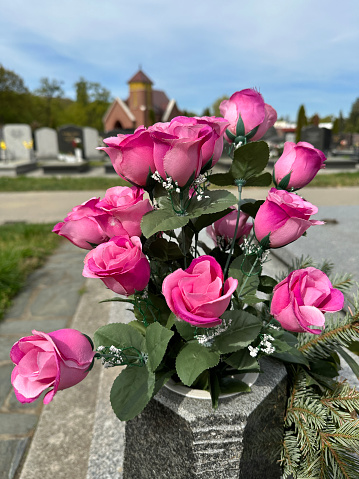 Artificial tulip flowers in a vase at the public cemetery