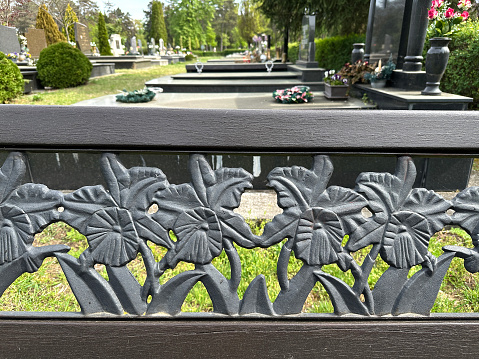 Ornate metal part of a bench in the public cemetery