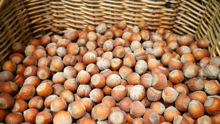 Close-up of many hazelnuts in wicker baskets