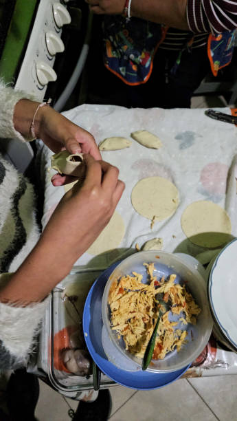 istock Woman's hands prepare molotes, which is corn dough filled with meat, a typical Mexican dish in a cookery in Mexico 2149472152