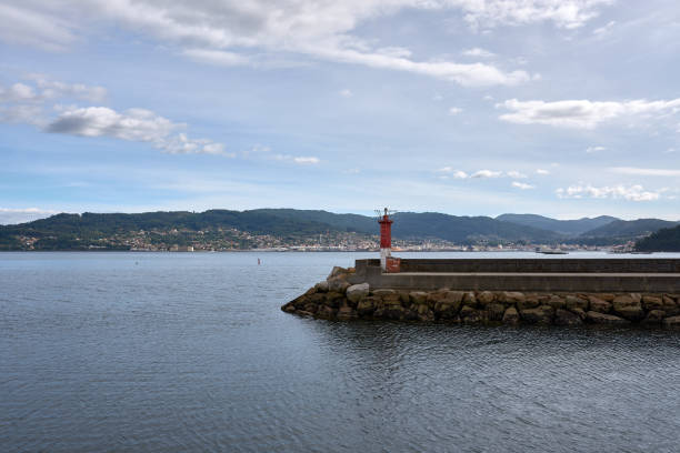 Shelter dock with the lighthouse at its end in the port of Combarro in the Ria de Pontevedra