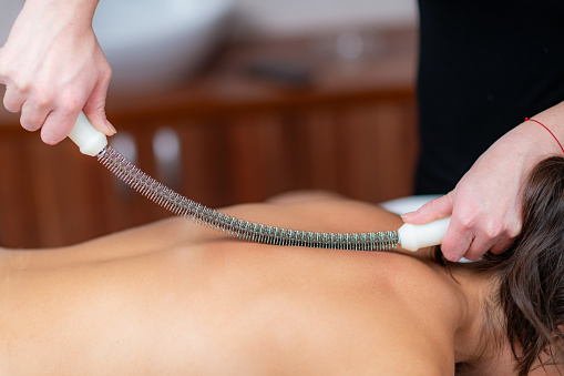 Body shaping massage as a metal rolling pin creates sculpted serenity, therapeutic treatment