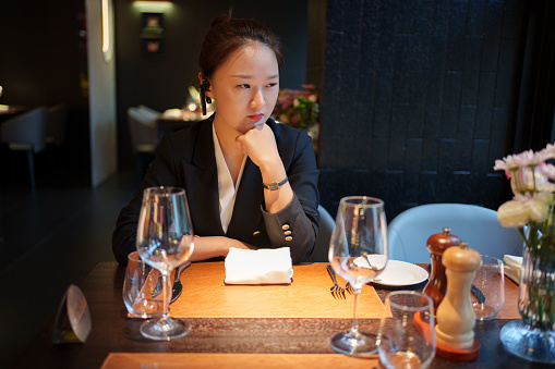 Asian woman sitting in restaurant