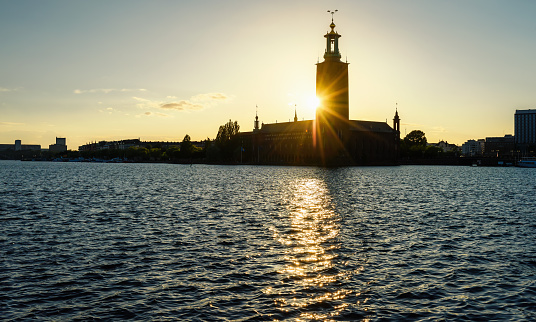 Silhouette of Stockholm City Hall (Stadshuset). Building of Municipal Council and venue of Nobel Prize on Kungsholmen Island at sunset. Sweden