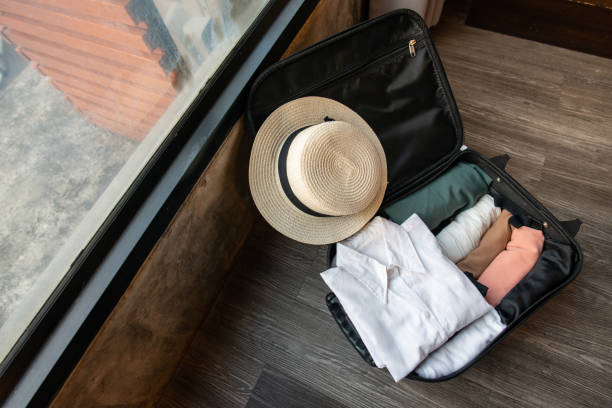istock Suitcase with colorful cloths packed for travelling. 2149482359