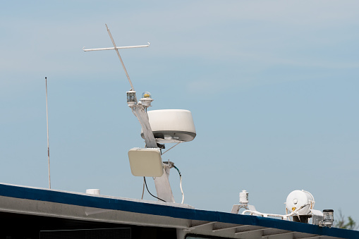 Radar and antennas on the top of the boat with a clear sky.