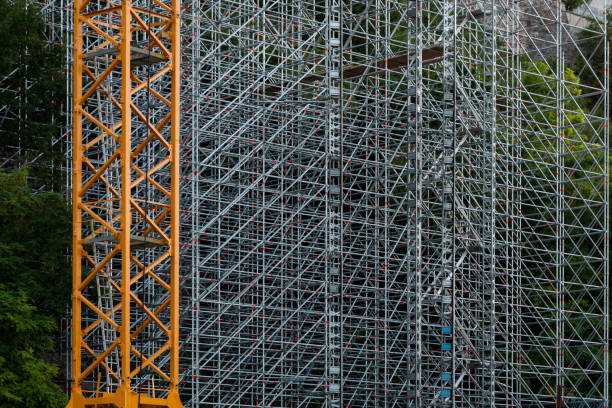 Intricate red scaffolding mesh on a new building under construction. Excellent choice as a wallpaper or for your presentations.