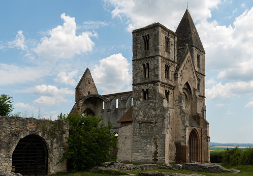 Ruins of a Premontre monastery church from the 13th century in Zsámbék with a cloudy sky in summer.