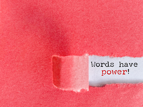 Inspirational Quote - Words have power text behind torn paper background. Stock photo.