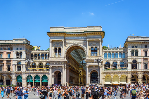 Milan, Italy - June 24, 2023: Milan historic quarter - Galleria Vittorio Emanuele II at the Cathedral square Piazza del Duomo. Tourists walk the streets of the city.