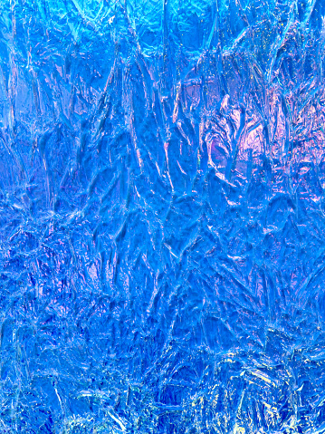 Blue ice as an abstract background. Texture.