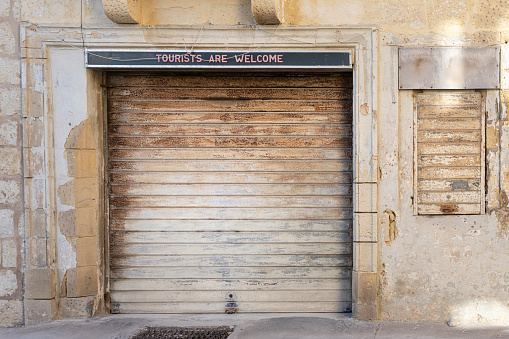 Valletta, Malta, April 03, 2024.  an old shop with the shutter closed in the city center