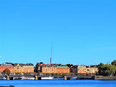 Stockholm. Sweden. 10/12/2022 Stockholm waterfront. Buildings in The Sweden capital city. The Bridge in capital city. Tour boat at the Stockholm waterfront.