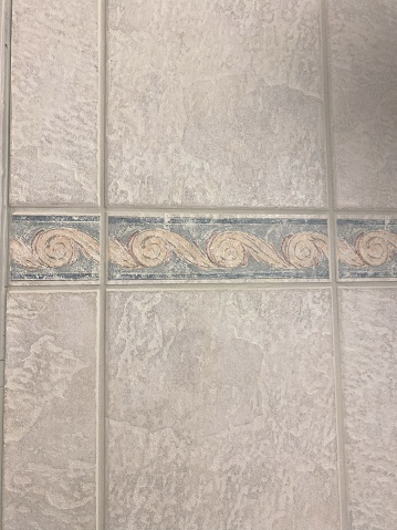 Bathroom walls are adorned with beige tiles