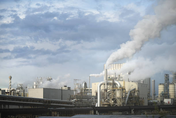 istock Industrial Factory Emits Smoke Against Cloudy Sky 2149490280