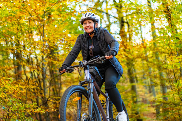 istock Woman riding bicycle in forest 2149490682